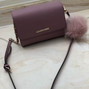 Purple purse with fluffy ball